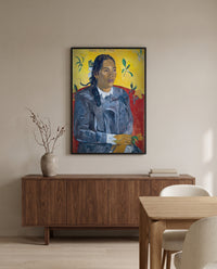 Woman with a Flower by Paul Gauguin in a black frame above a walnut sideboard in a dining room