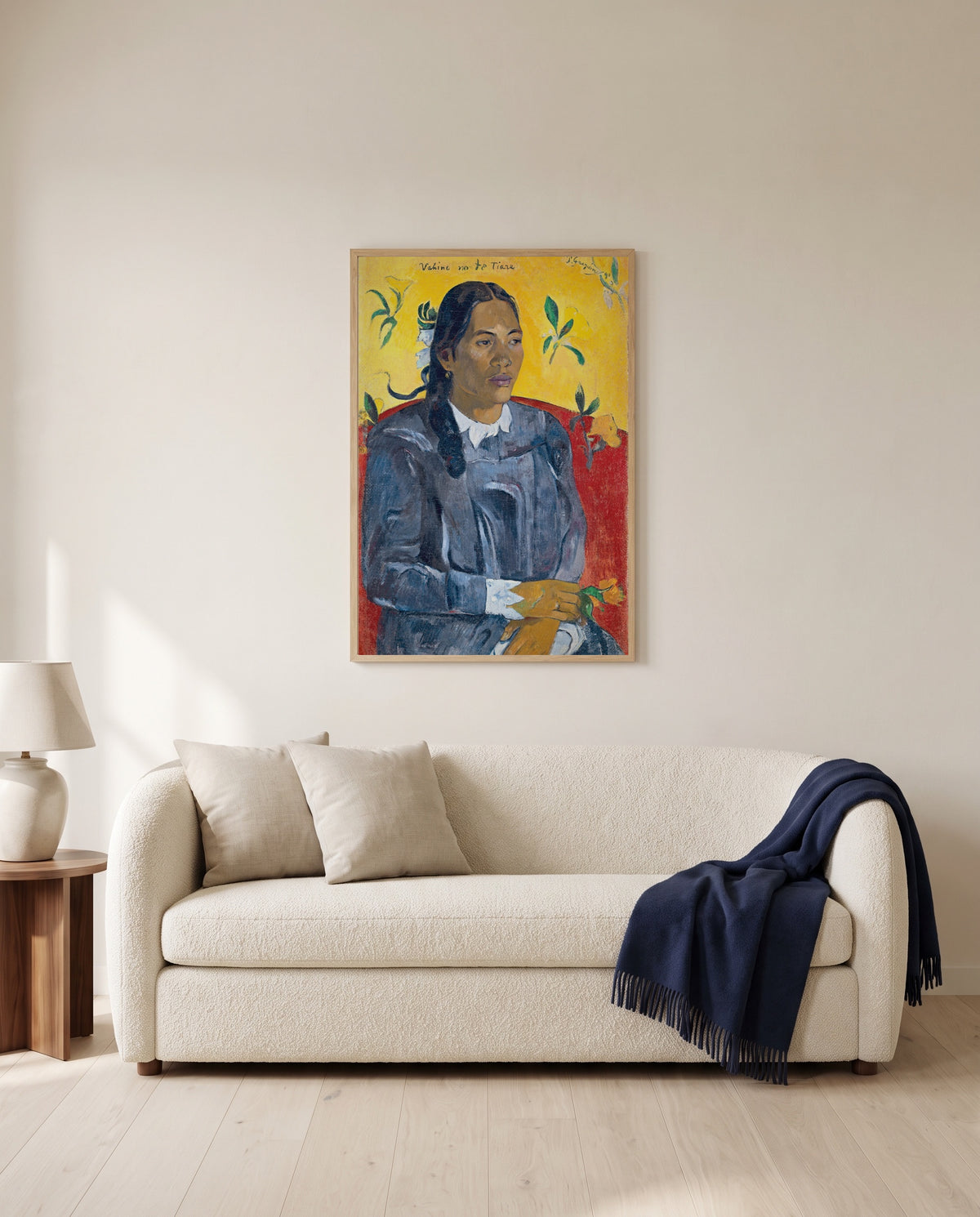 Woman with a Flower by Paul Gauguin framed in natural oak above a cream sofa in a warm living room