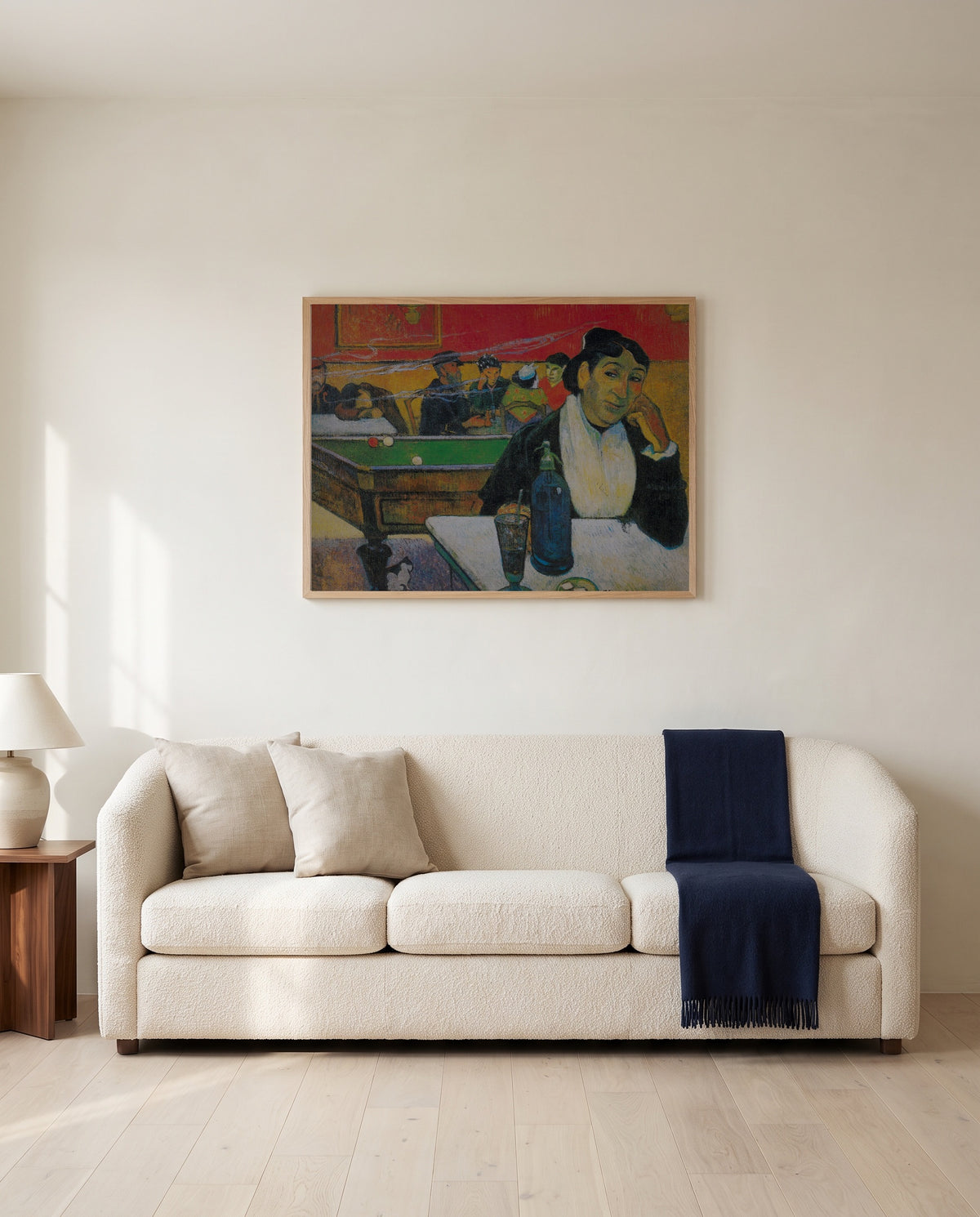 The Night Café at Arles by Paul Gauguin framed in natural oak above a cream sofa in a warm living room