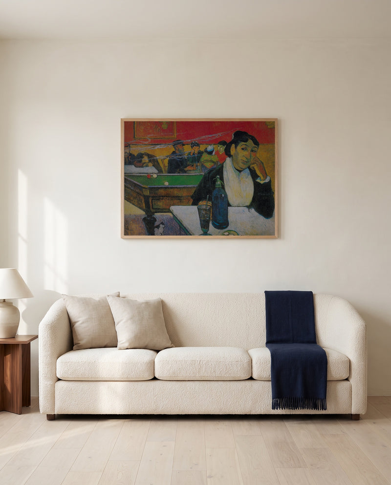 The Night Café at Arles by Paul Gauguin framed in natural oak above a cream sofa in a warm living room