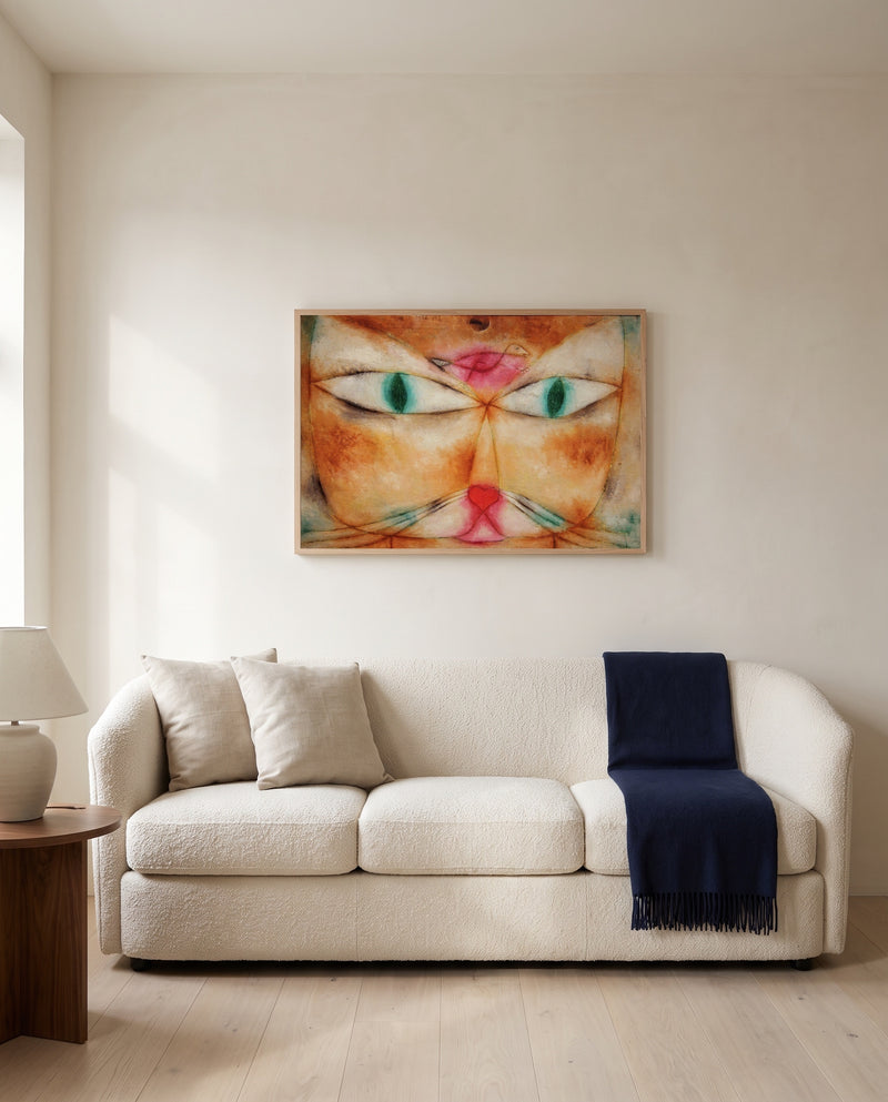 Cat and Bird by Paul Klee framed in natural oak above a cream sofa in a warm living room
