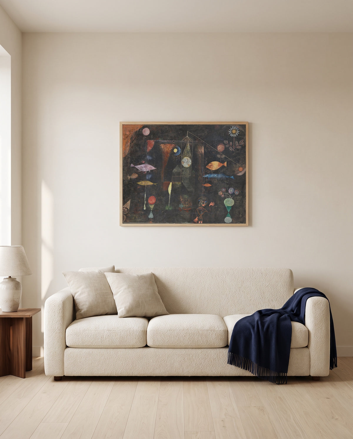 Fish Magic by Paul Klee framed in natural oak above a cream sofa in a warm living room