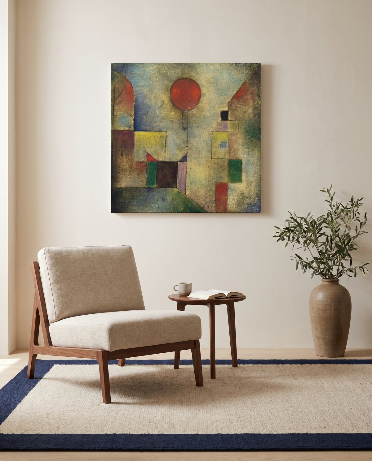 Red Balloon by Paul Klee as a stretched canvas above a linen lounge chair in a reading corner