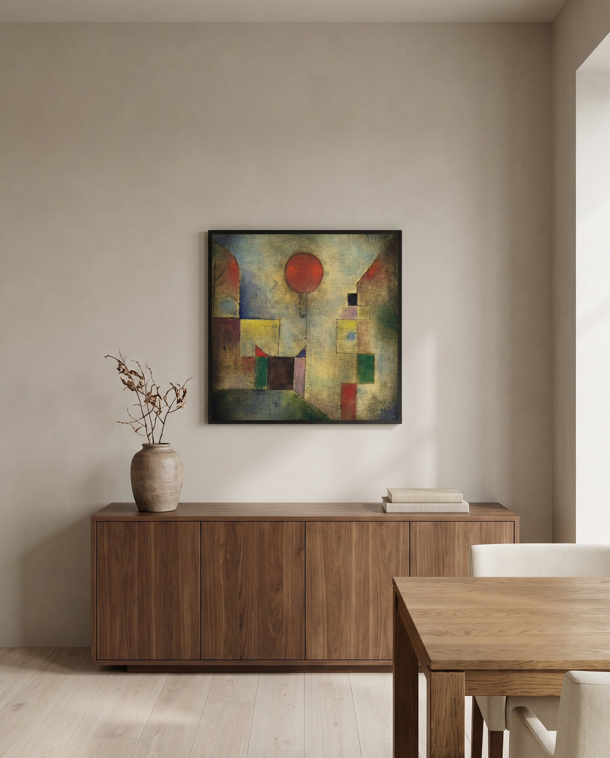Red Balloon by Paul Klee in a black frame above a walnut sideboard in a dining room