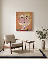 Senecio by Paul Klee as a stretched canvas above a linen lounge chair in a reading corner