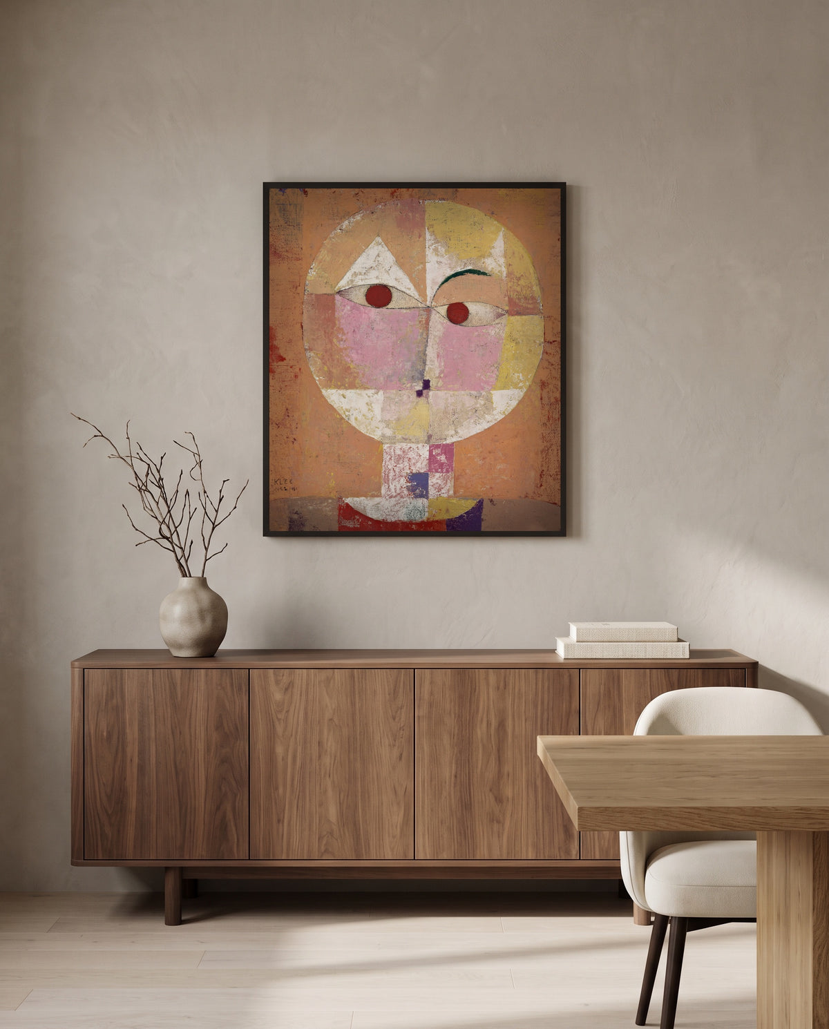 Senecio by Paul Klee in a black frame above a walnut sideboard in a dining room