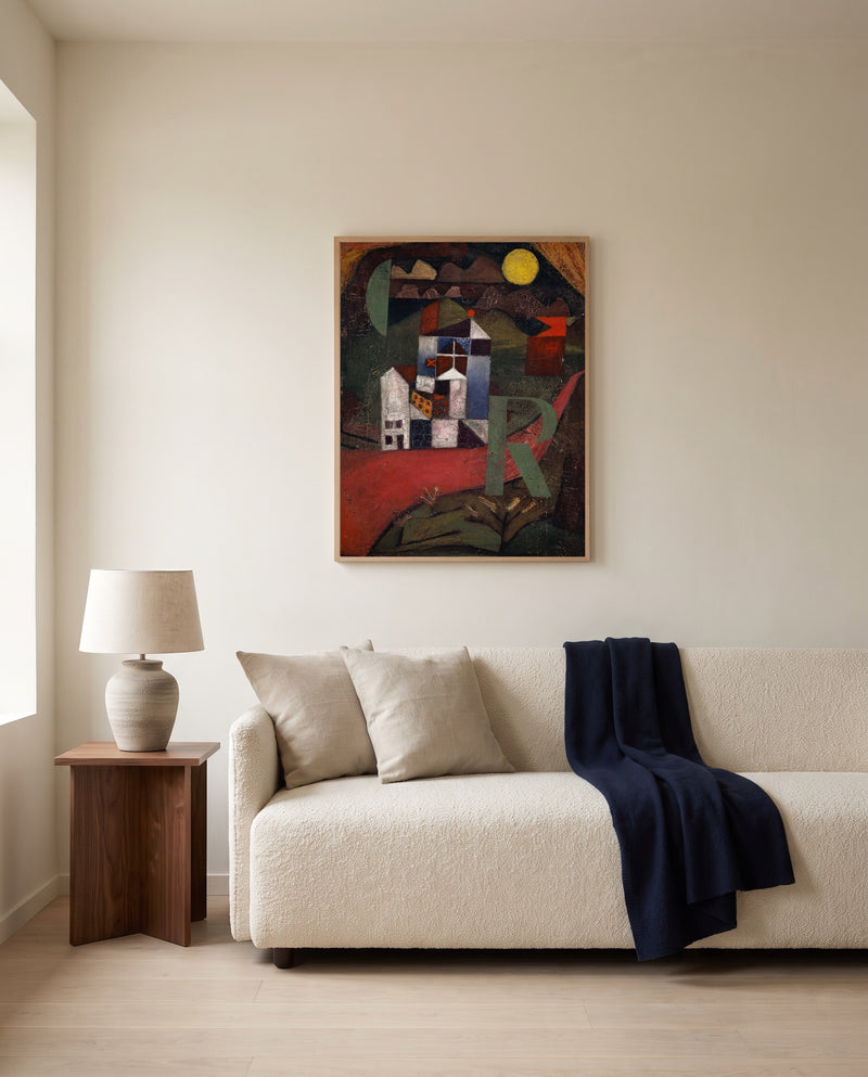 Villa R by Paul Klee framed in natural oak above a cream sofa in a warm living room