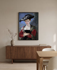 Le Chapeau de Paille by Peter Paul Rubens in a black frame above a walnut sideboard in a dining room