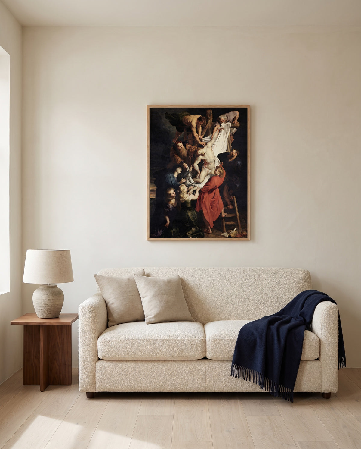 The Descent from the Cross by Peter Paul Rubens framed in natural oak above a cream sofa in a warm living room