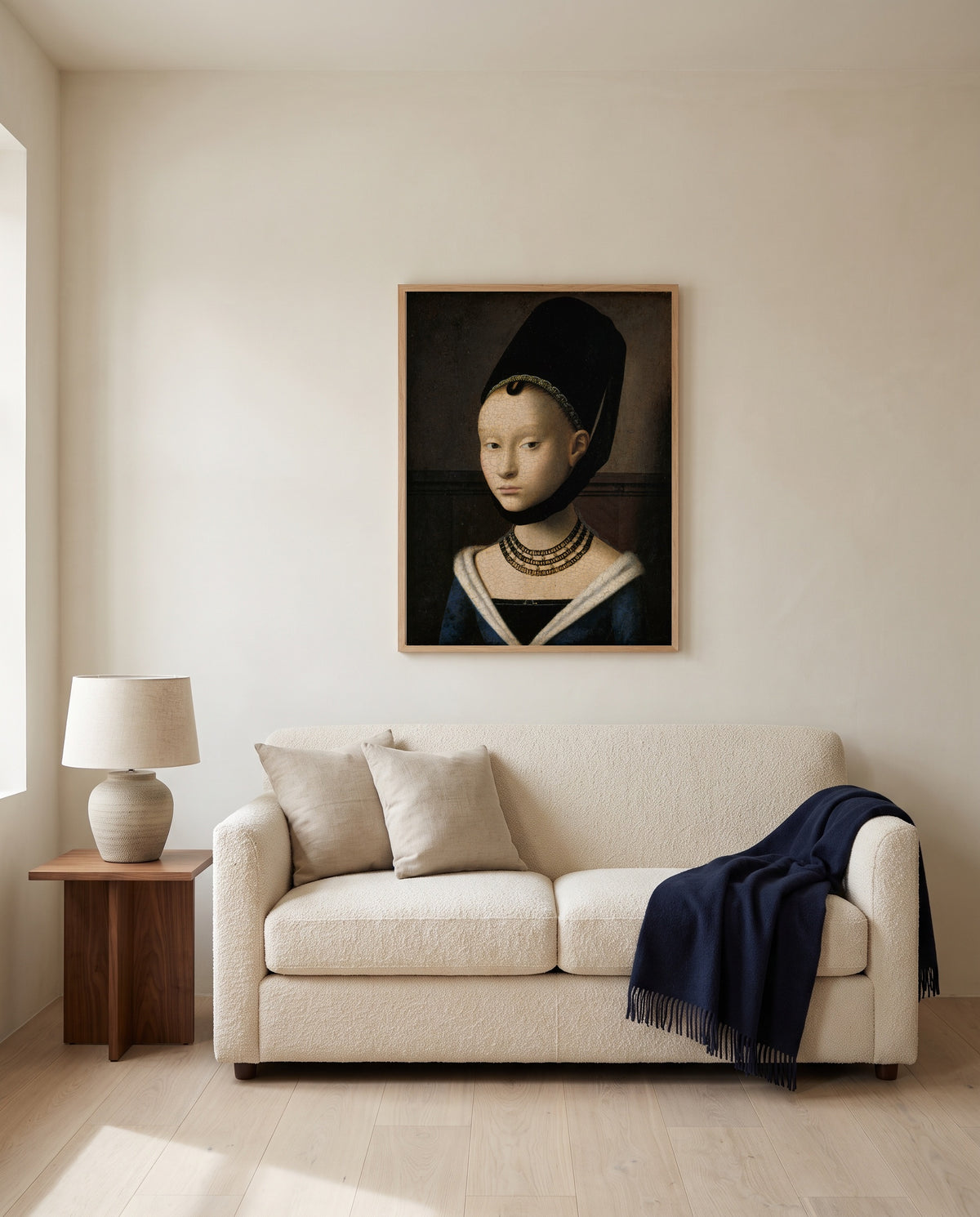Portrait of a Young Girl by Petrus Christus framed in natural oak above a cream sofa in a warm living room