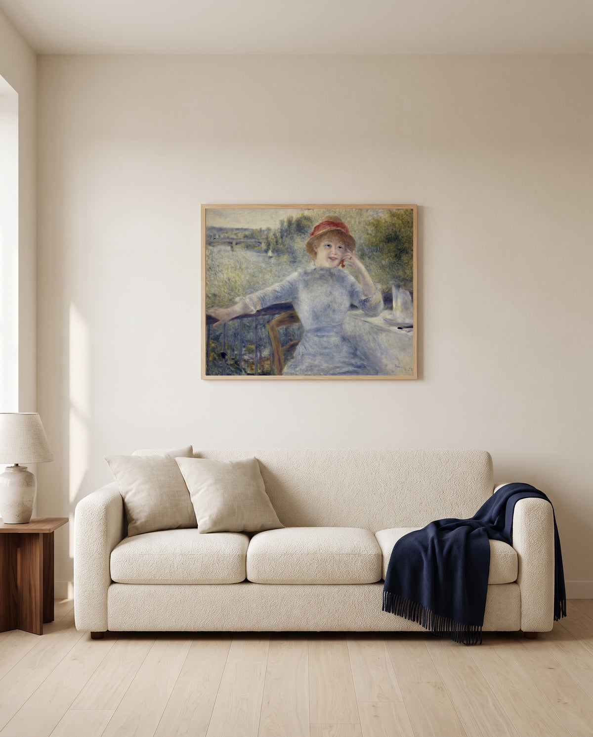 Alphonsine Fournaise by Pierre-Auguste Renoir framed in natural oak above a cream sofa in a warm living room