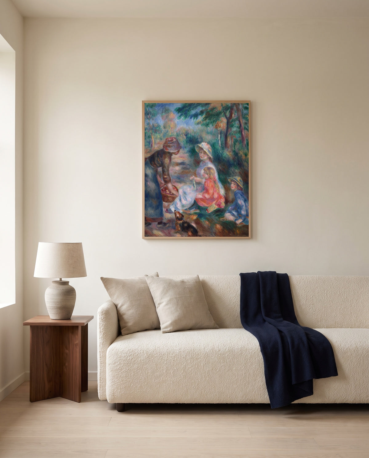 The Apple Seller by Pierre-Auguste Renoir framed in natural oak above a cream sofa in a warm living room