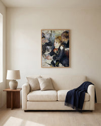 At the Milliner’s by Pierre-Auguste Renoir framed in natural oak above a cream sofa in a warm living room