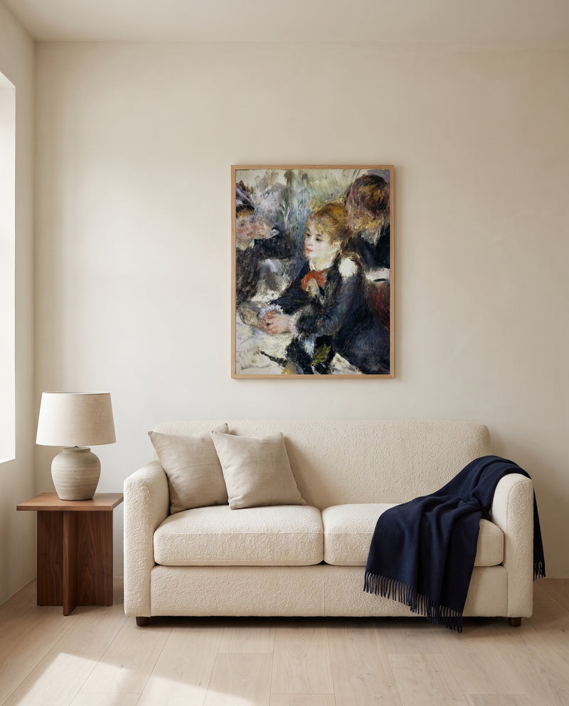 At the Milliner’s by Pierre-Auguste Renoir framed in natural oak above a cream sofa in a warm living room