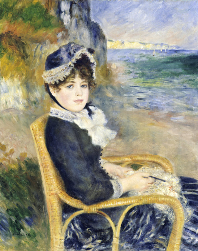 By the Seashore by Renoir: a young woman in dark blue in a wicker chair holding needlework, cliffs and the sea behind her