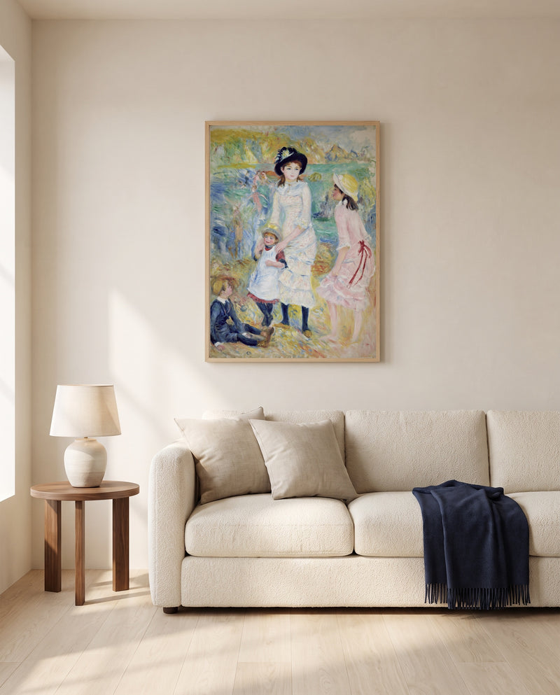 Children on the Seashore by Pierre-Auguste Renoir framed in natural oak above a cream sofa in a warm living room