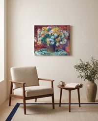 Chrysanthemums by Pierre-Auguste Renoir as a stretched canvas above a linen lounge chair in a reading corner