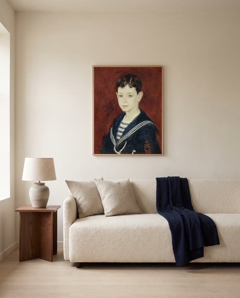 Fernand Halphen as a Boy by Pierre-Auguste Renoir framed in natural oak above a cream sofa in a warm living room