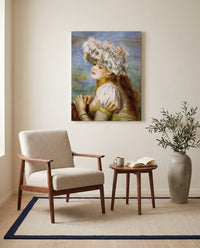 Girl in a Lace Hat by Pierre-Auguste Renoir as a stretched canvas above a linen lounge chair in a reading corner