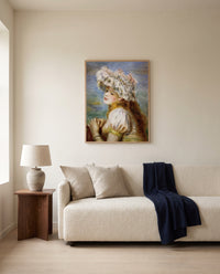 Girl in a Lace Hat by Pierre-Auguste Renoir framed in natural oak above a cream sofa in a warm living room