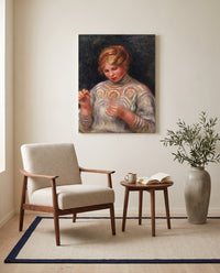 Girl Tatting by Pierre-Auguste Renoir as a stretched canvas above a linen lounge chair in a reading corner