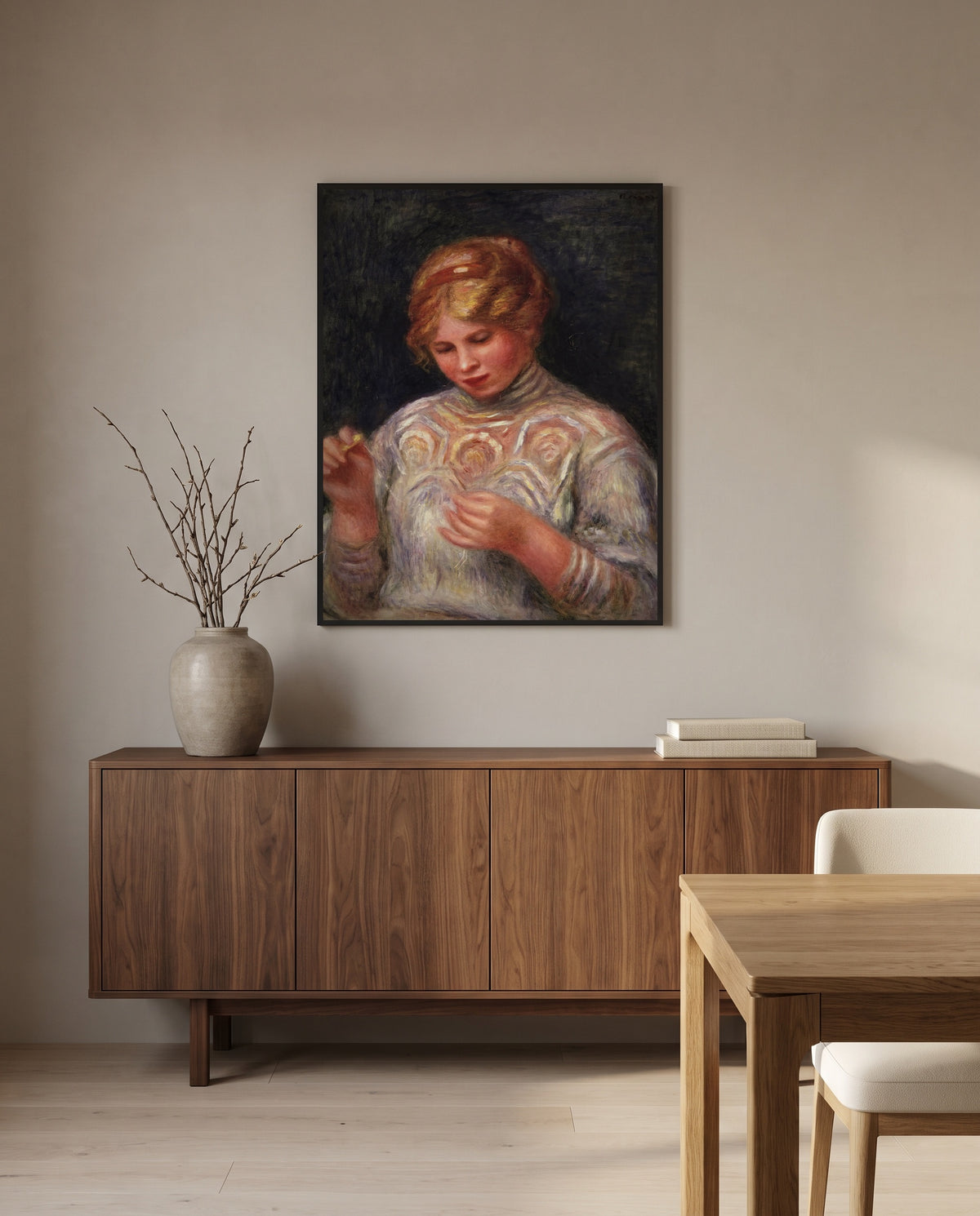 Girl Tatting by Pierre-Auguste Renoir in a black frame above a walnut sideboard in a dining room