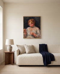 Girl Tatting by Pierre-Auguste Renoir framed in natural oak above a cream sofa in a warm living room