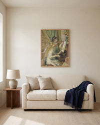 Young Girls at the Piano by Pierre-Auguste Renoir framed in natural oak above a cream sofa in a warm living room