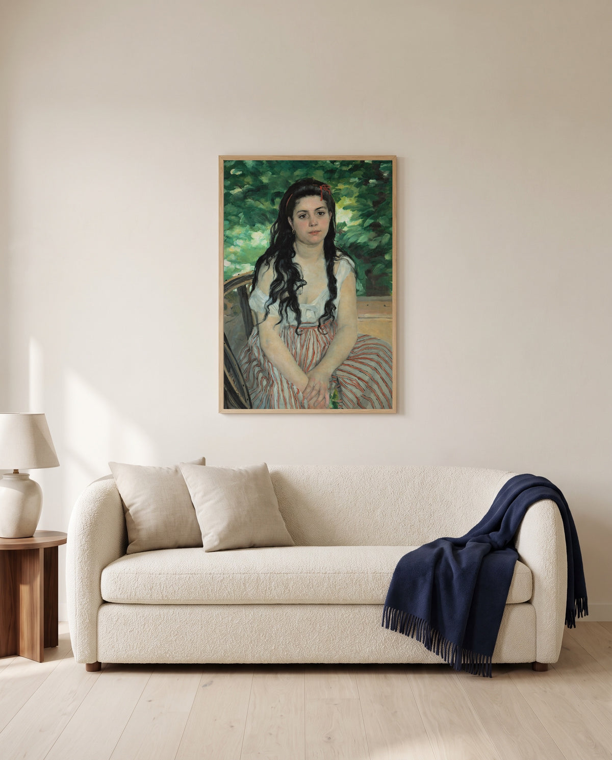 In Summer by Pierre-Auguste Renoir framed in natural oak above a cream sofa in a warm living room