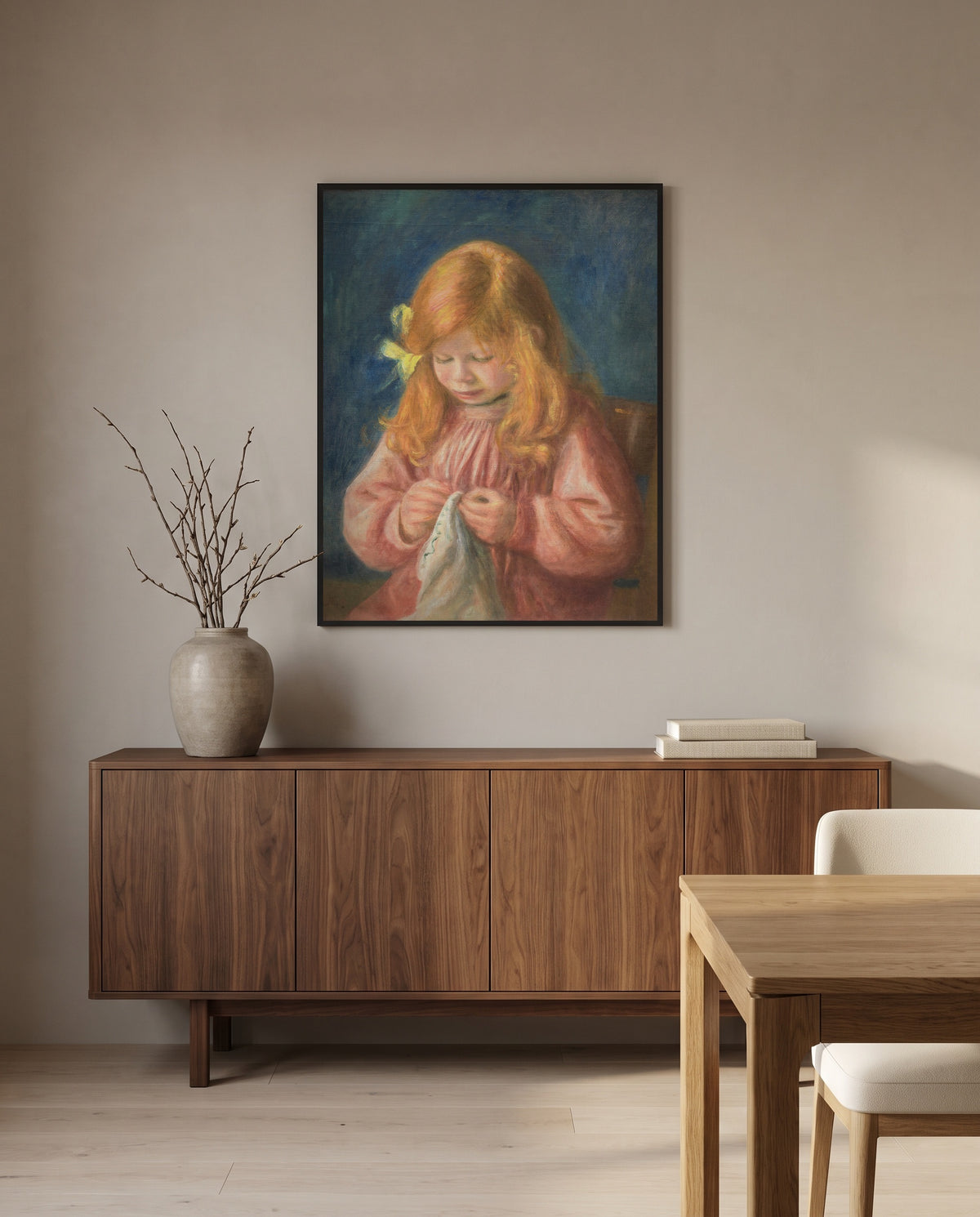 Jean Renoir Sewing by Pierre-Auguste Renoir in a black frame above a walnut sideboard in a dining room