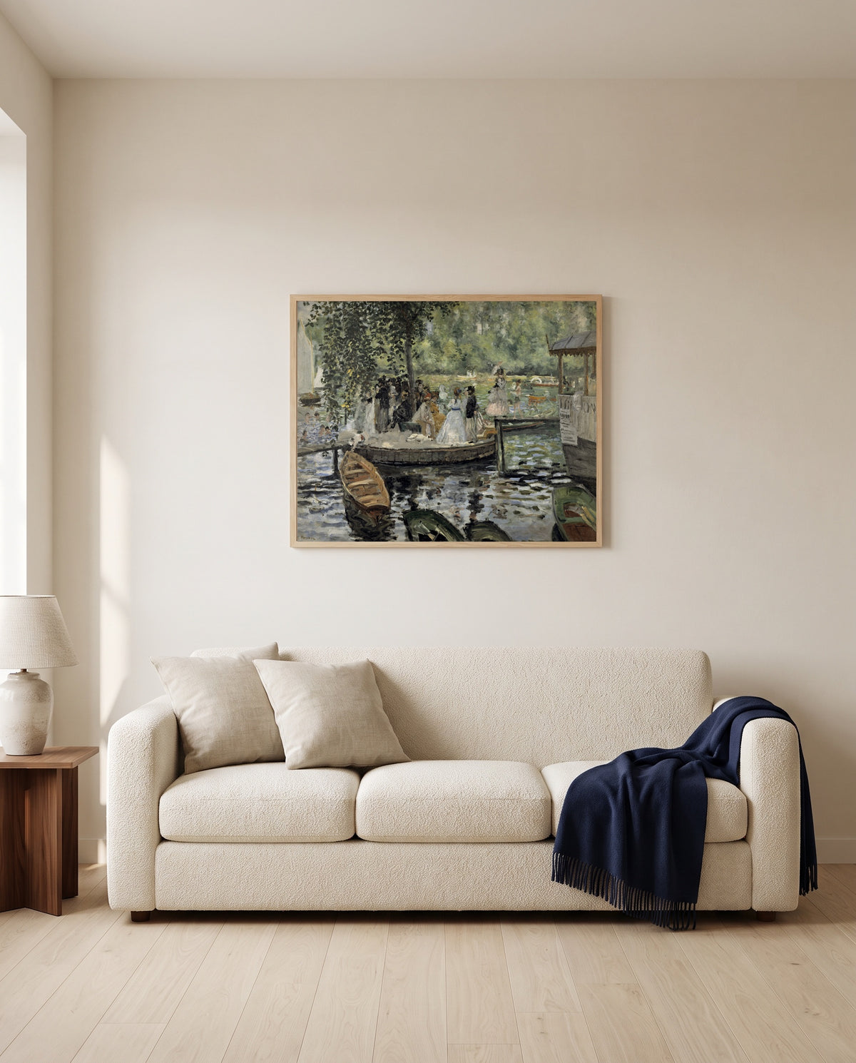 La Grenouillère by Pierre-Auguste Renoir framed in natural oak above a cream sofa in a warm living room
