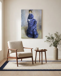 La Parisienne by Pierre-Auguste Renoir as a stretched canvas above a linen lounge chair in a reading corner