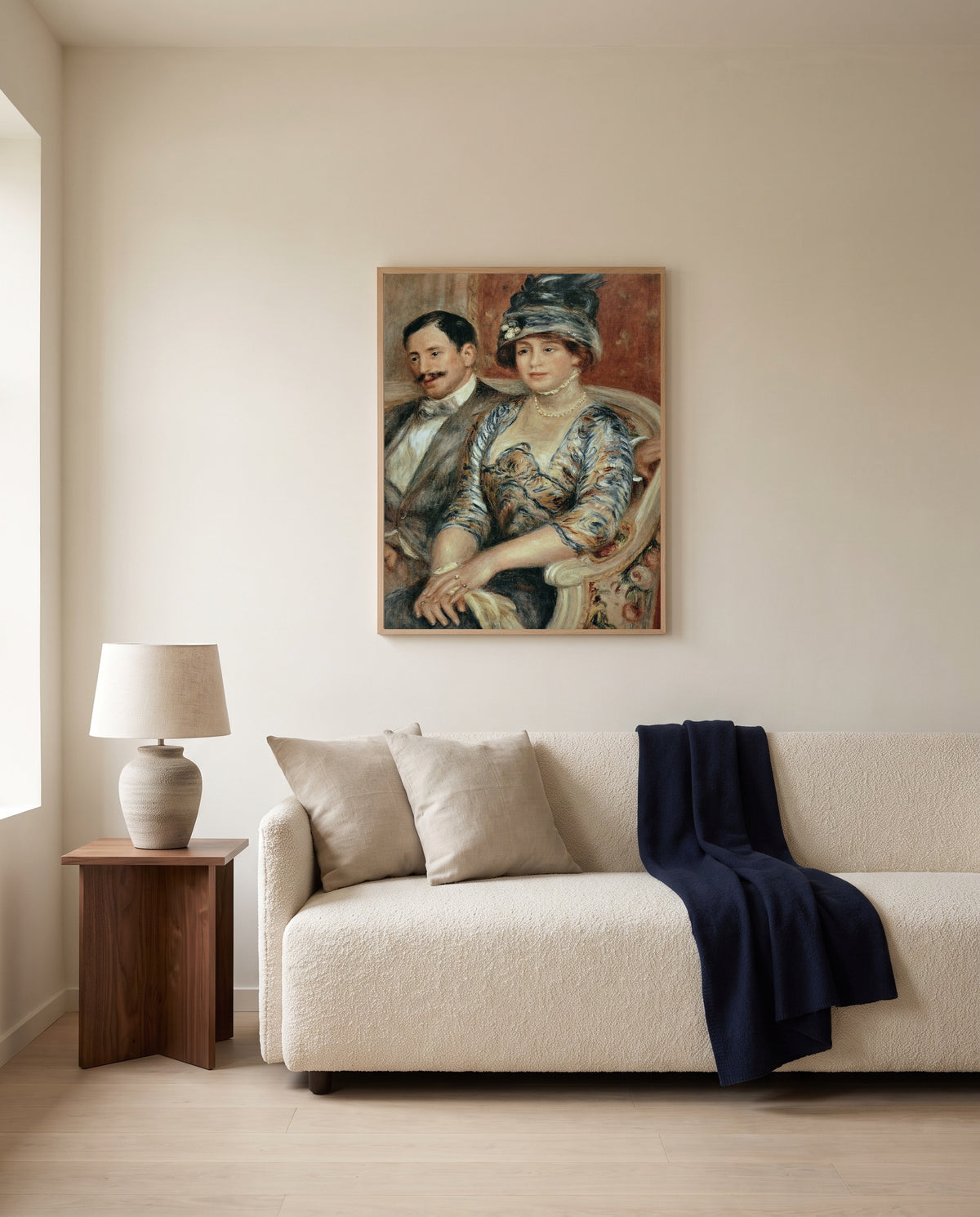 Mr and Mrs Bernheim by Pierre-Auguste Renoir framed in natural oak above a cream sofa in a warm living room