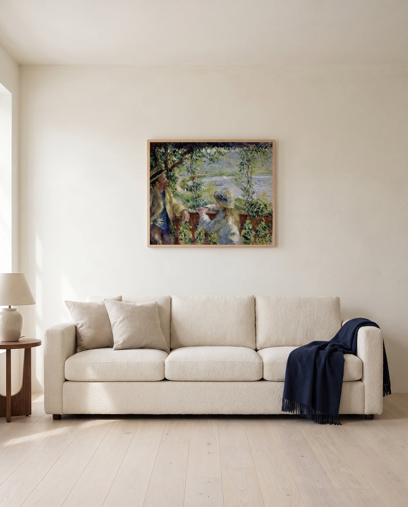 Near the Lake by Pierre-Auguste Renoir framed in natural oak above a cream sofa in a warm living room
