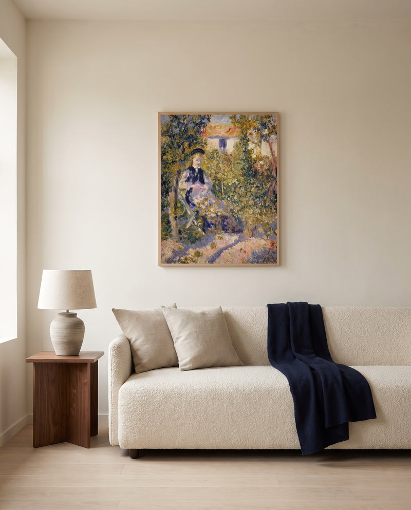 Nini in the Garden by Pierre-Auguste Renoir framed in natural oak above a cream sofa in a warm living room