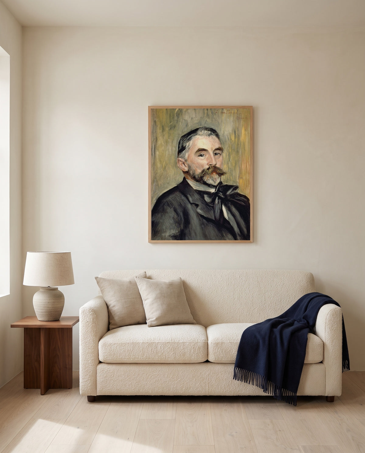 Stéphane Mallarmé by Pierre-Auguste Renoir framed in natural oak above a cream sofa in a warm living room