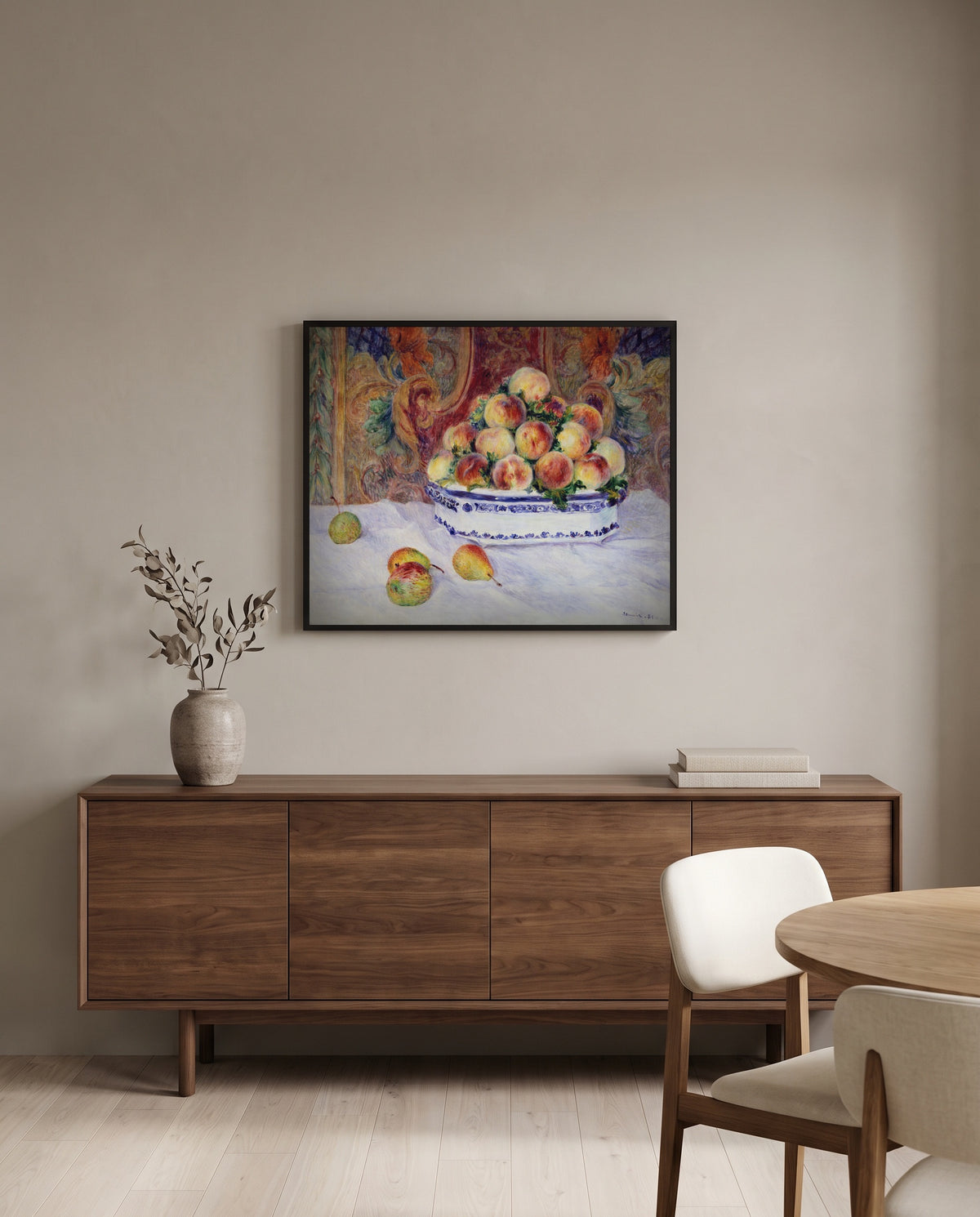 Still Life with Peaches by Pierre-Auguste Renoir in a black frame above a walnut sideboard in a dining room