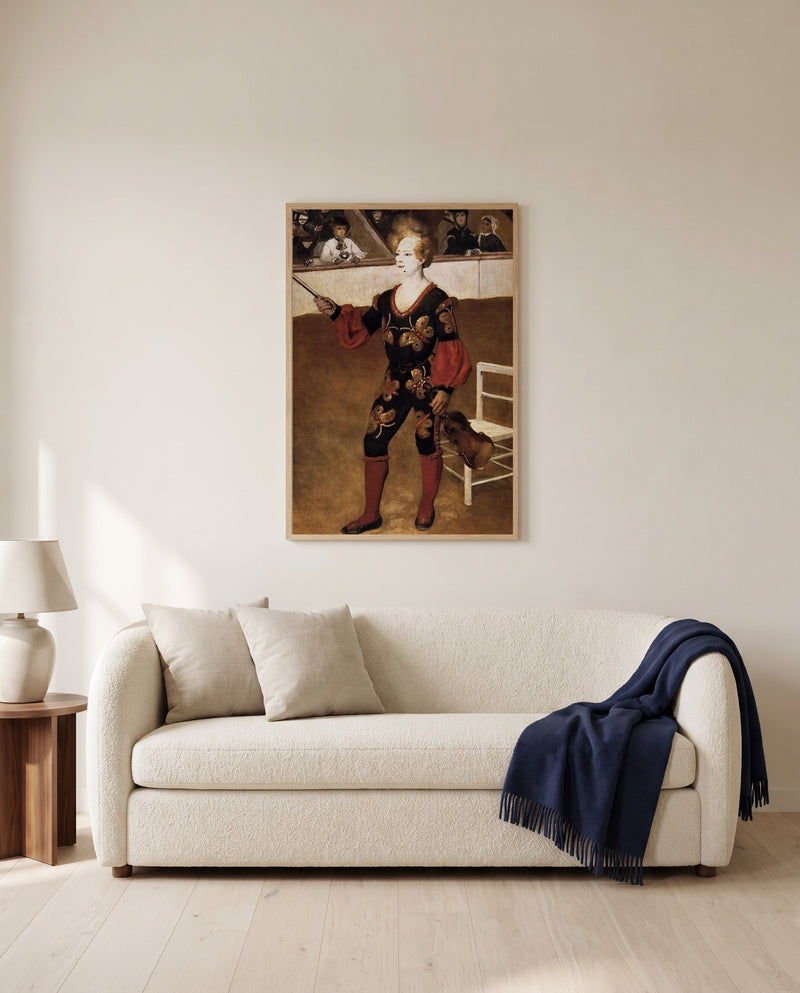The Clown by Pierre-Auguste Renoir framed in natural oak above a cream sofa in a warm living room