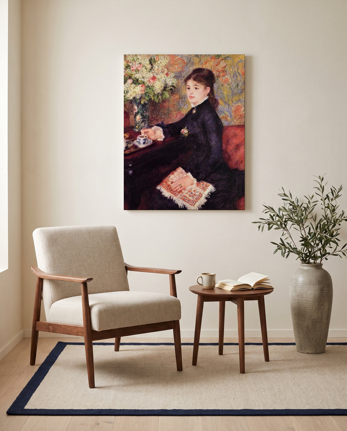 The Cup of Chocolate by Pierre-Auguste Renoir as a stretched canvas above a linen lounge chair in a reading corner