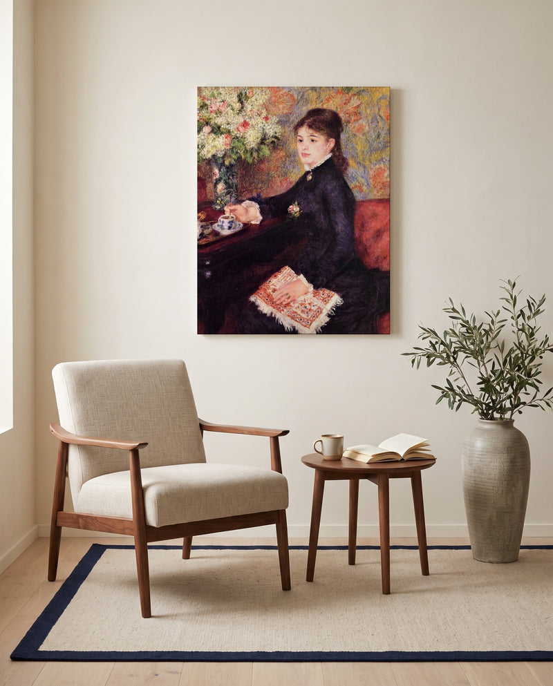 The Cup of Chocolate by Pierre-Auguste Renoir as a stretched canvas above a linen lounge chair in a reading corner