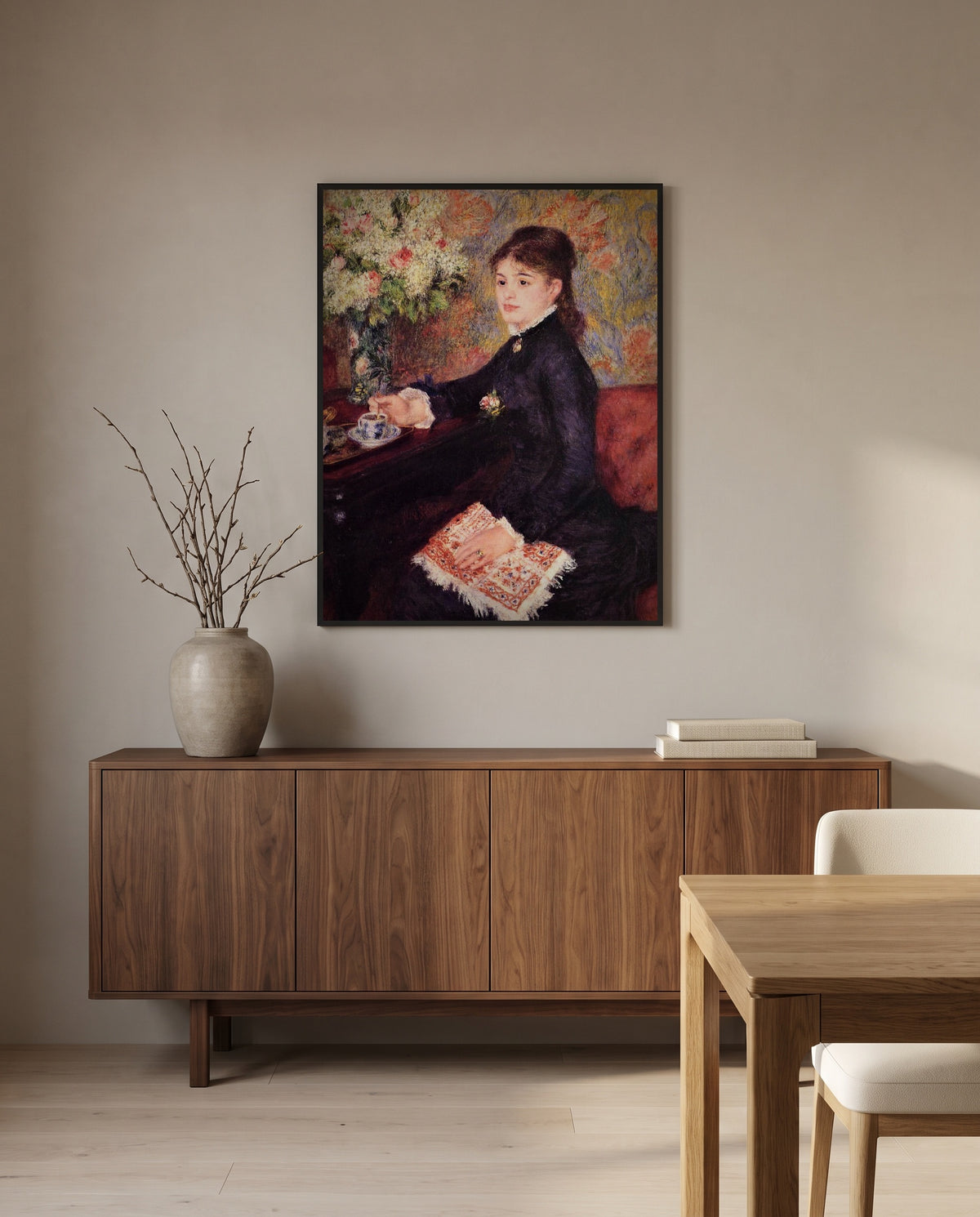The Cup of Chocolate by Pierre-Auguste Renoir in a black frame above a walnut sideboard in a dining room