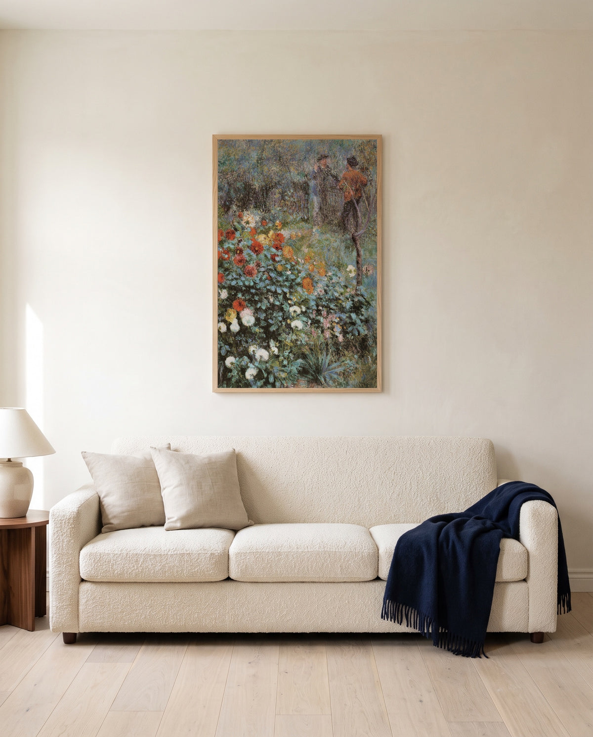 Garden in the Rue Cortot by Pierre-Auguste Renoir framed in natural oak above a cream sofa in a warm living room