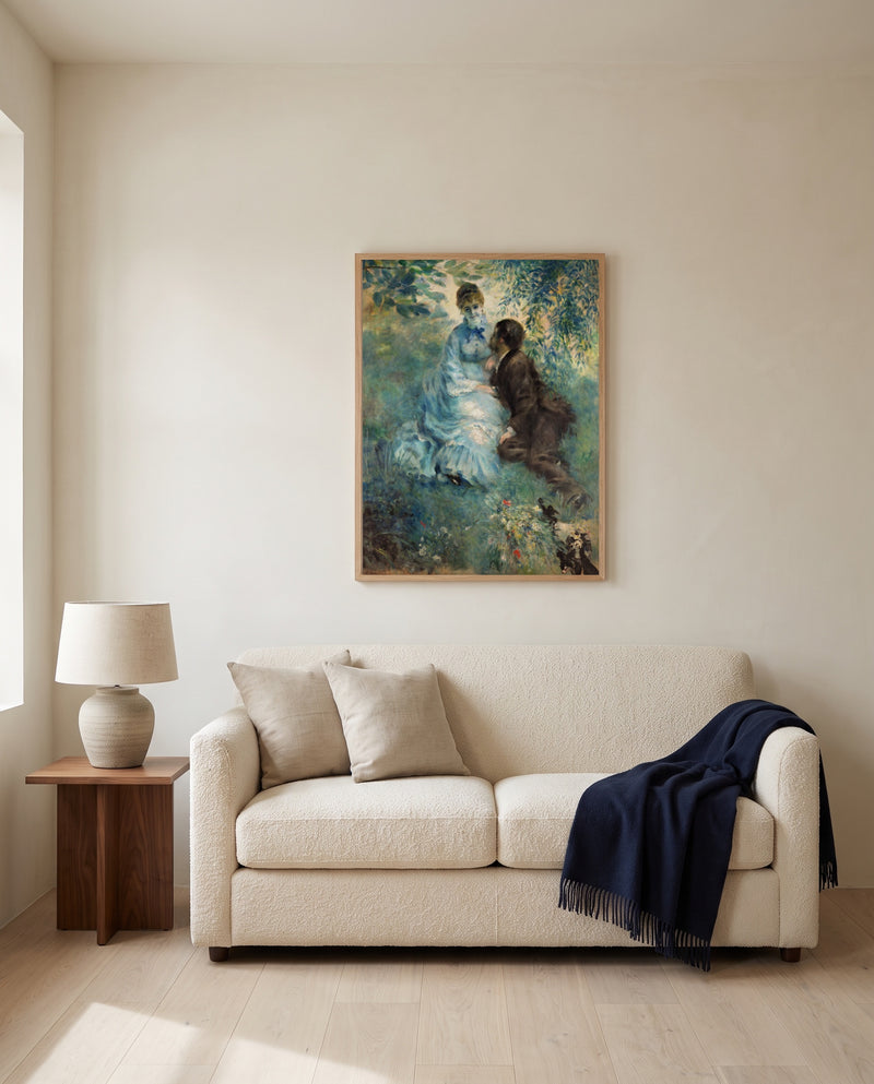The Lovers by Pierre-Auguste Renoir framed in natural oak above a cream sofa in a warm living room