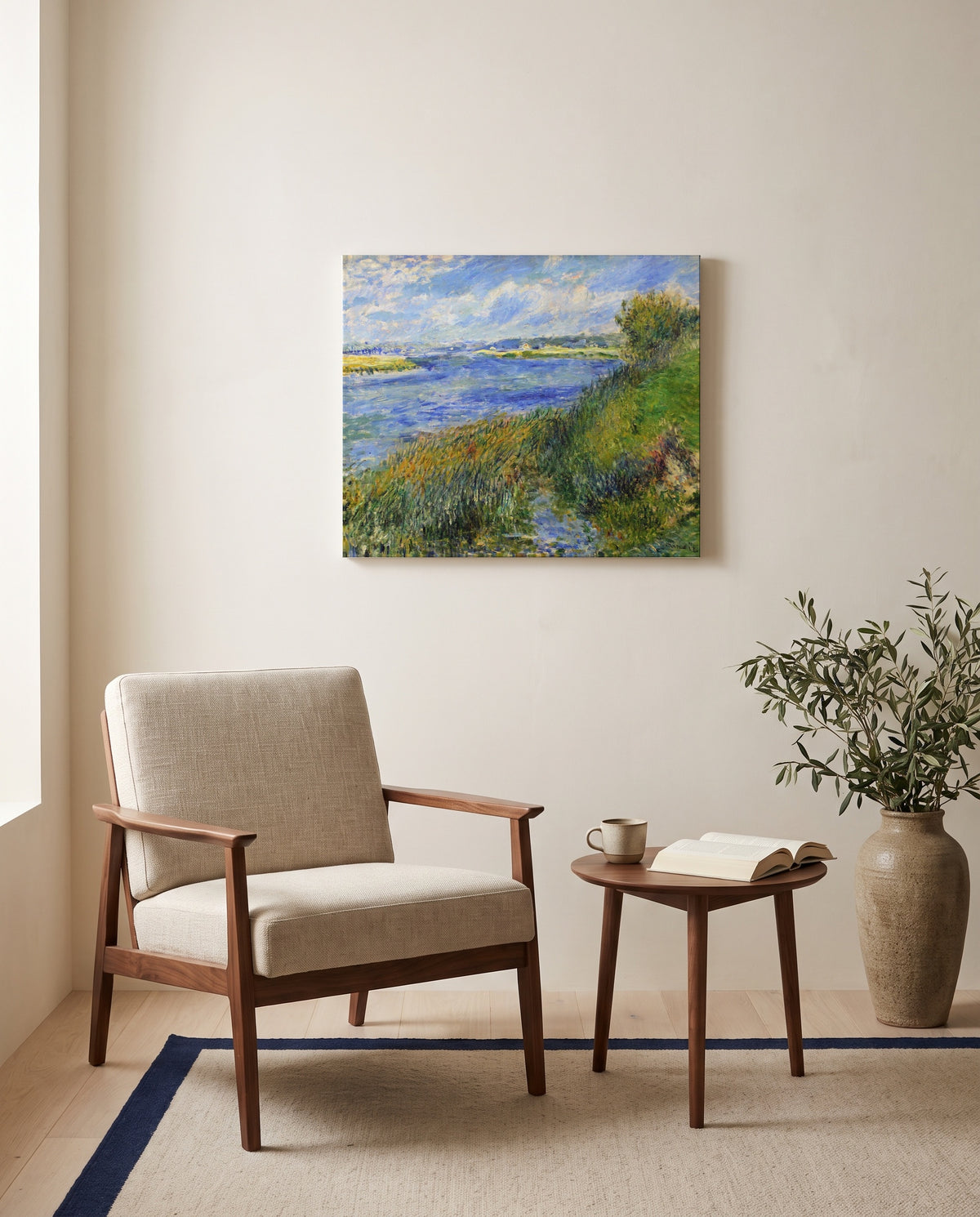The Seine at Champrosay by Pierre-Auguste Renoir as a stretched canvas above a linen lounge chair in a reading corner