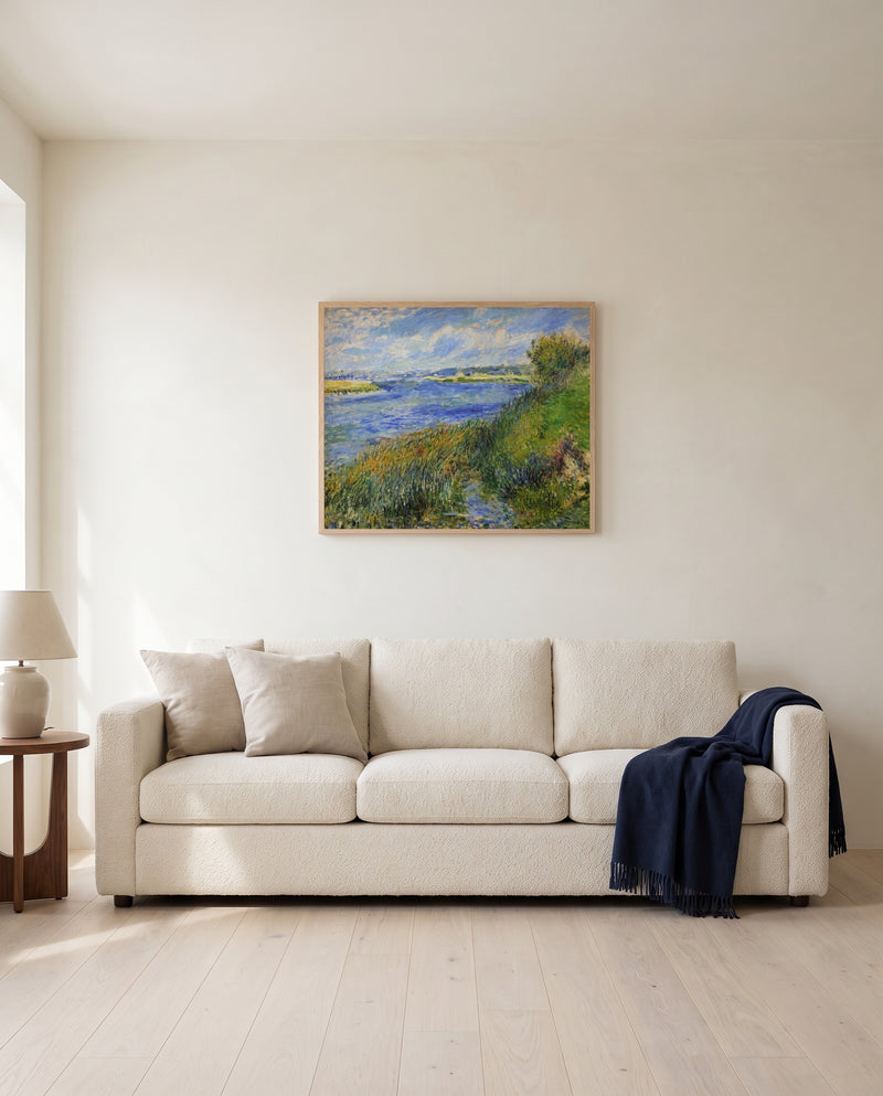 The Seine at Champrosay by Pierre-Auguste Renoir framed in natural oak above a cream sofa in a warm living room