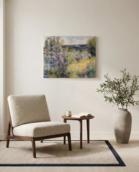The Seine at Chatou by Pierre-Auguste Renoir as a stretched canvas above a linen lounge chair in a reading corner