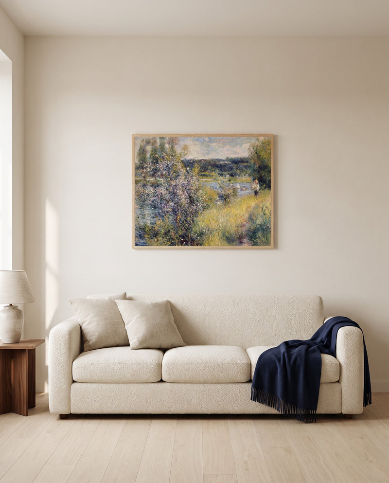 The Seine at Chatou by Pierre-Auguste Renoir framed in natural oak above a cream sofa in a warm living room