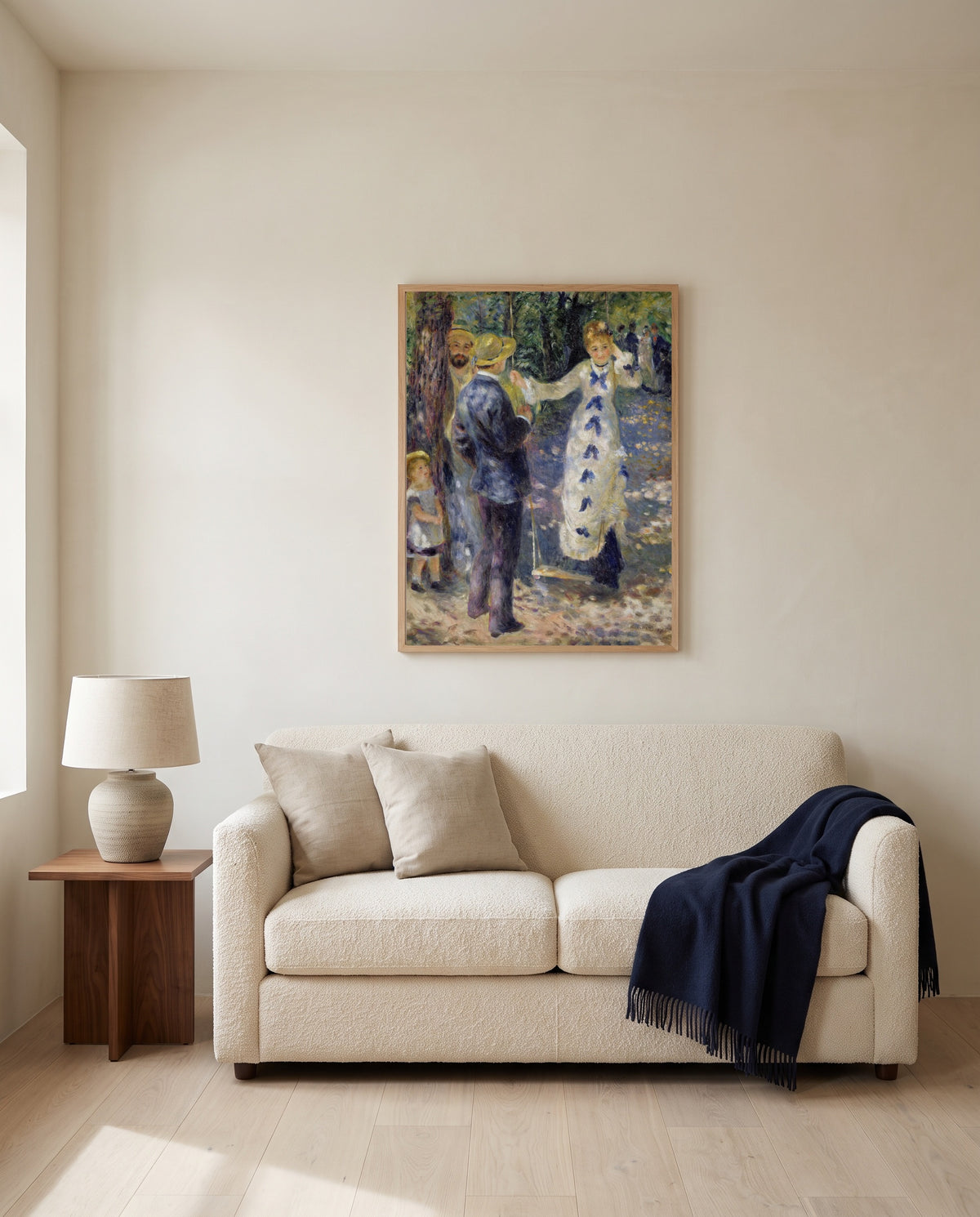 The Swing by Pierre-Auguste Renoir framed in natural oak above a cream sofa in a warm living room