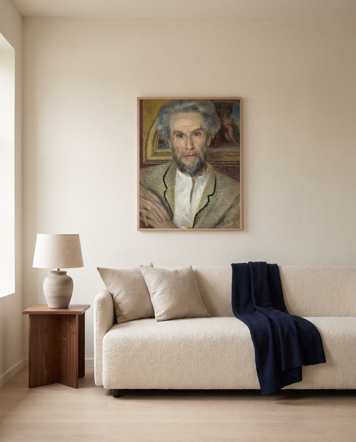 Victor Chocquet by Pierre-Auguste Renoir framed in natural oak above a cream sofa in a warm living room