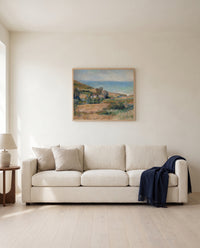 Seacoast near Wargemont by Pierre-Auguste Renoir framed in natural oak above a cream sofa in a warm living room
